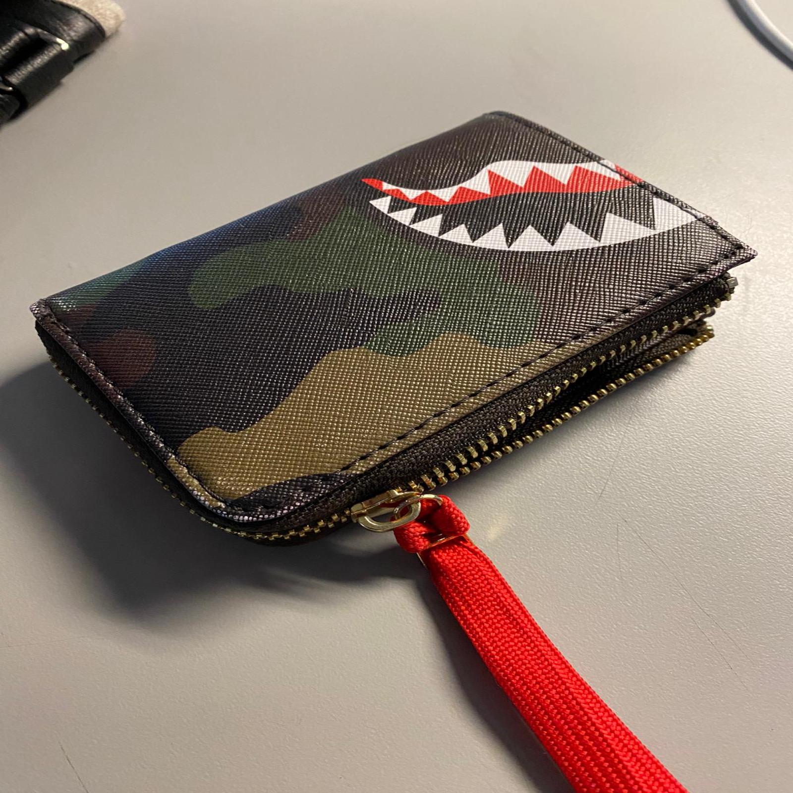 The sound of the wallet's zipper opening